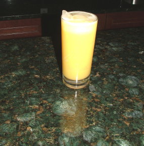 Here is my own Brazilian Verde Peacock granite bar top. This glass of orange juice looks pretty harmless, but the ice will evenutally create condensation and a glass ring. A further danger is the citric acid in the orange juice. Who knows what it might do to unsealed granite? 