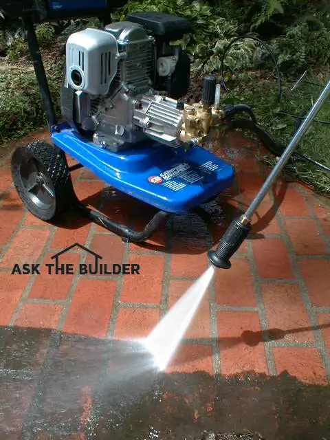 pressure washer cleaning brick patio