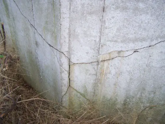 These are severe cracks in a poured concrete retaining wall. There are ways to stabilize the wall without tearing it down and starting over. Photo Credit: John Oliveras