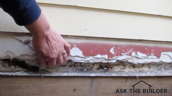 This is an inferior metal flashing that's on top of the wood and extends up behind the siding. It was supposed to be longer and the metal bent over the bare piece of lumber. Photo Credit: Tim Carter