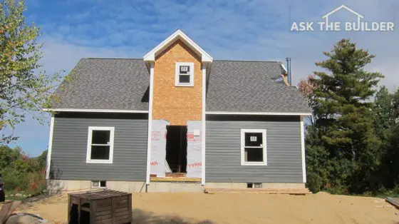 The off-center window above the door and the chimney disaster at the roofline may be part of a severe systemic problem with the builder. Photo Credit: Tim Carter