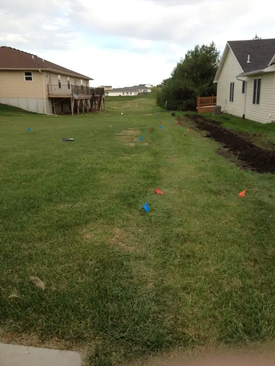 You can see standing water next to the house on the right. Lots of water flows down the grassy area from the top of the hill. Photo Credit: Mike Hardy