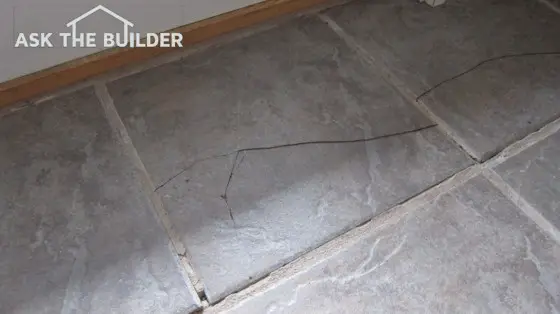 This ceramic floor tile has a big crack in it and is dangerous for those with bare feet. Photo credit: Tim Carter