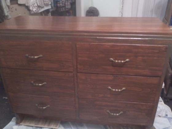 Joy's finished dresser with the replacement drawer, a new finish and the new pulls.