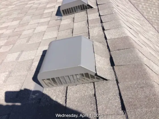 Here's Dr. Jane's pot or turtle vents. Those upturned shingles are creating a spot where wind-driven rain can gain access to the underside of the vent flashing with relative ease. Photo credit: Someone holding a smart phone camera