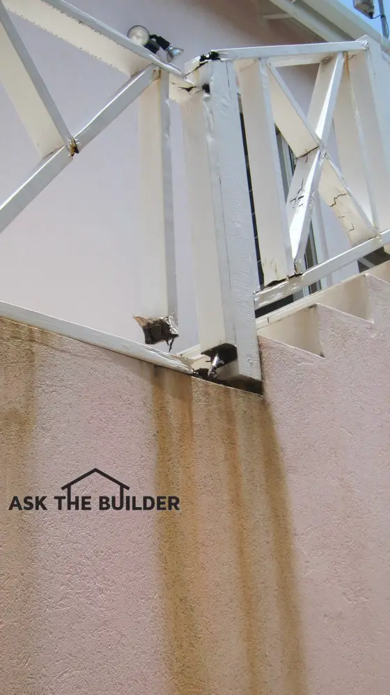 This wood railing rotted out in less than eight years. It’s just one of many construction defects in this new home. Photo credit: Tim Carter