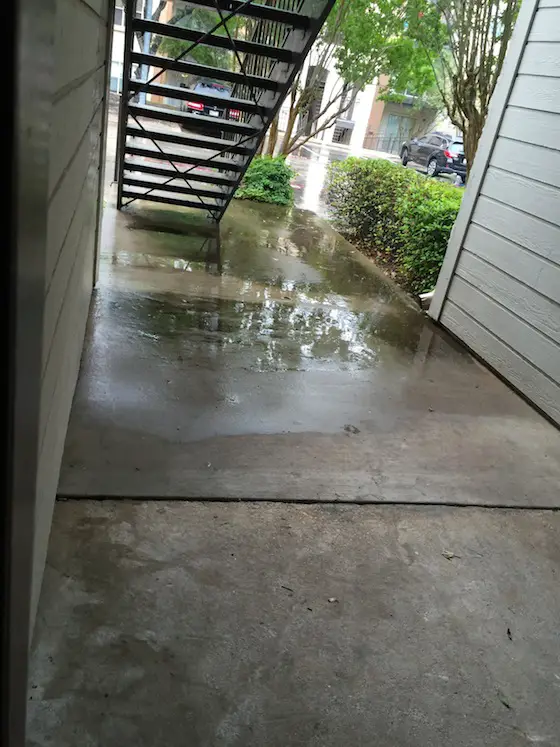 You can see that pesky downspout elbow next to the bushes at the corner of the condo. Photo credit: Judi Adkins