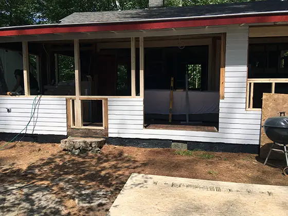 This summer cabin in the woods of Maine is going to become a year-round home after the extensive remodel. Photo Credit: Rick Bader