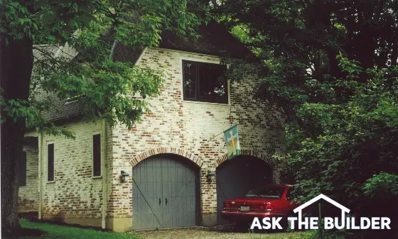 garage doors with arched brick opening