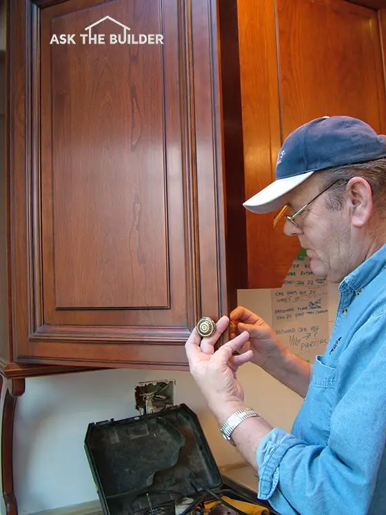 cabinet pulls being installed