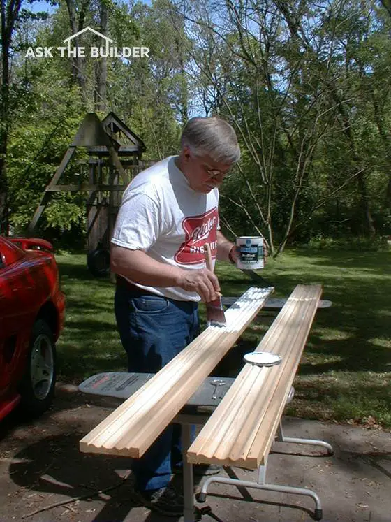 Tim painting woodwork outside