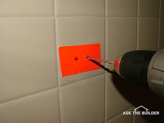 drilling ceramic tile red tape on wall