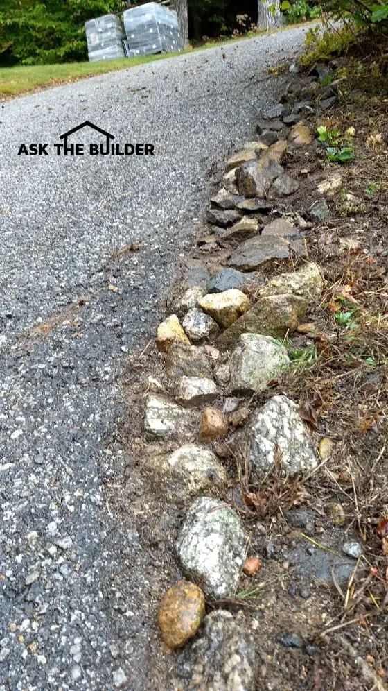 large stones blacktop driveway erosion