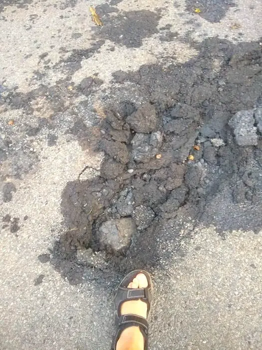 Hole in road from power line down