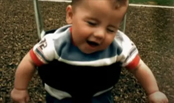 toddler in swing blinking