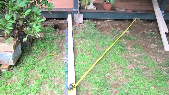 tape measure squaring board off a deck