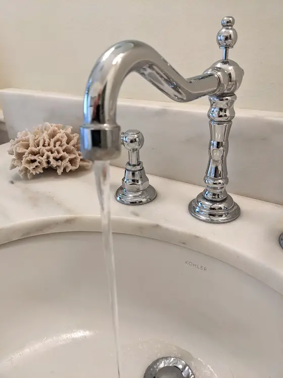 water running from vanity faucet