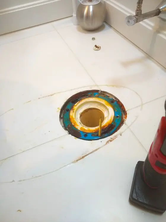 toilet flange buried under new tile floor