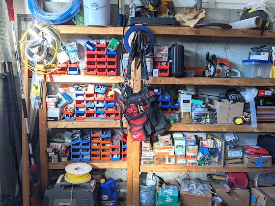 shelving in a garage filled with hardware clutter
