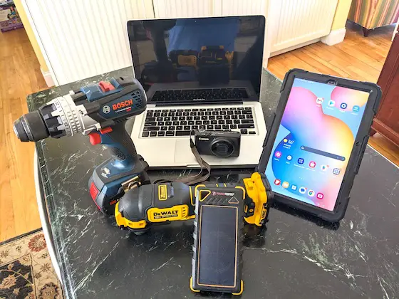 drill, laptop, camera, tablet on kitchen counter