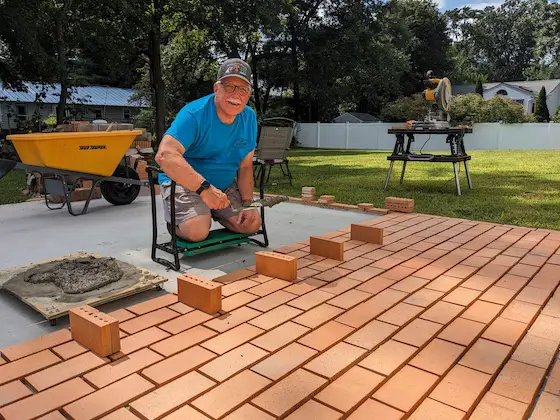 tim carter laying clay paving brick on concrete