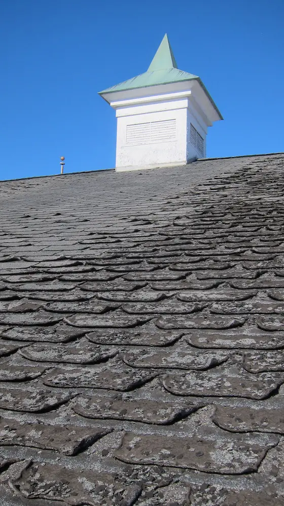 worn asphalt shingles cupola with copper roof