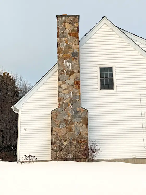 stone chimney with leak and efflorescence salts