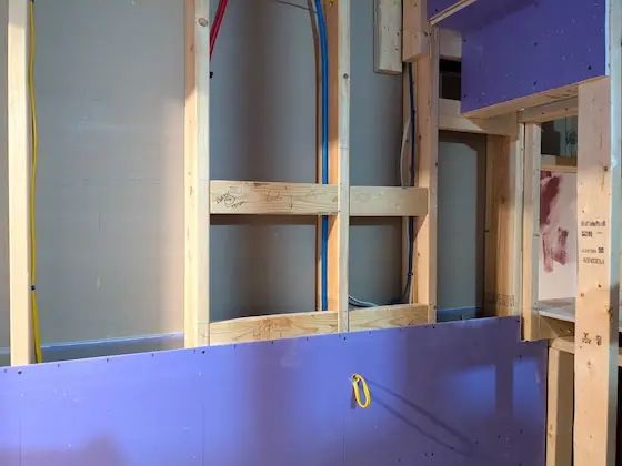 interior house wall partially covered with drywall