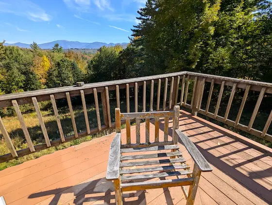 deck railing and chair with mountain view new hampshire