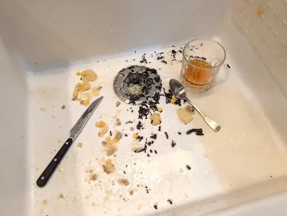 dirty kitchen sink with food waste