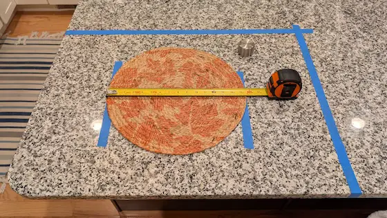 granite countertop with placemat and painter's tape