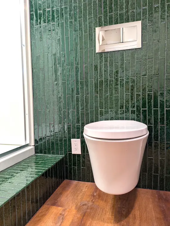wall-hung toilet green subway tile